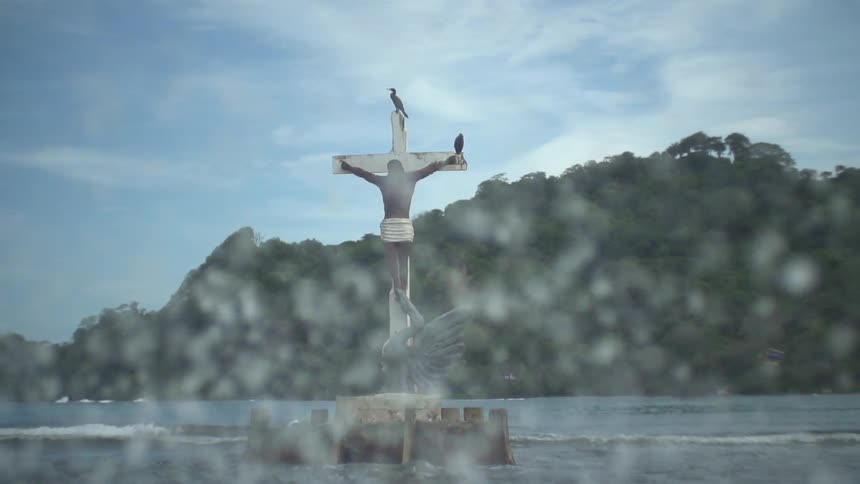 Statue of a man crucified floating in the water