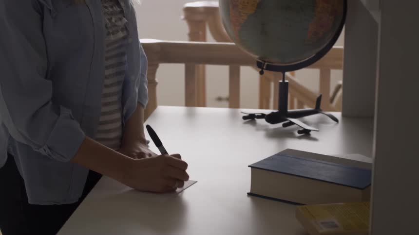 A woman writing on a card