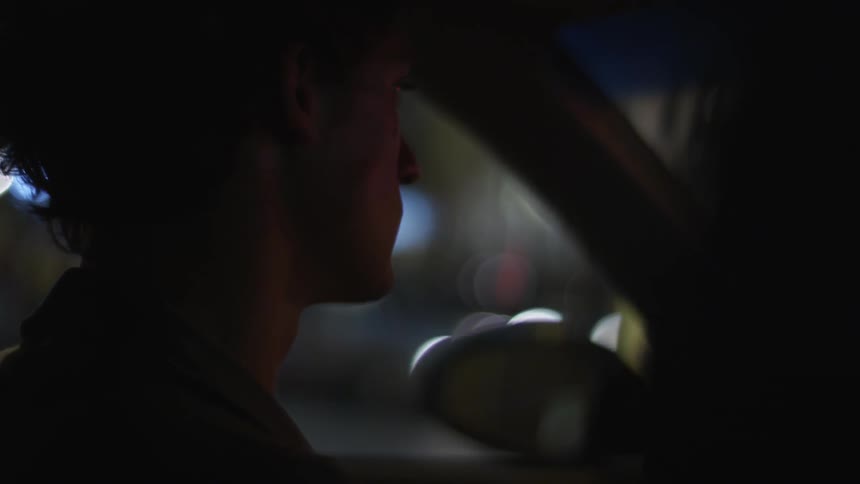 Man driving a vehicle at night