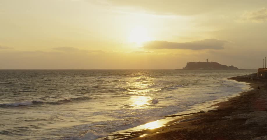 The sun is sitting on the beach