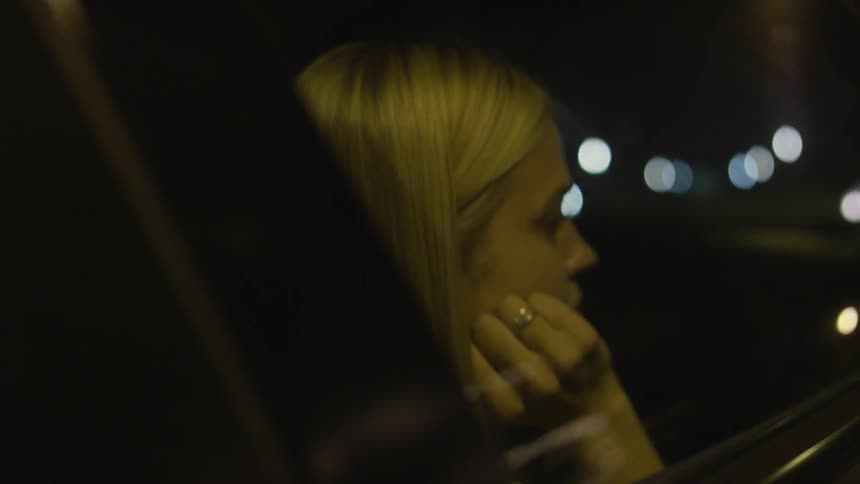 Woman sitting in a car looking out the window