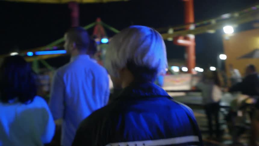People walking a carnival at night