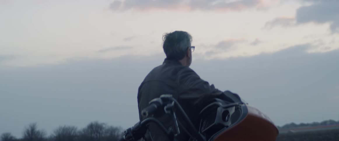 Motorcyclist stops to enjoy a sunset