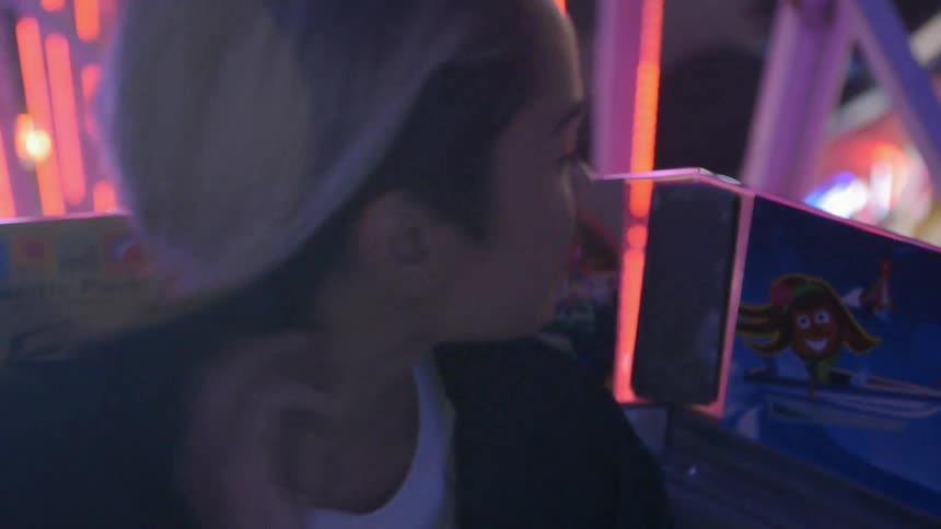 Woman looks over her shoulder to some bright lights
