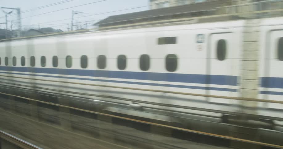 Train is traveling very fast through a city