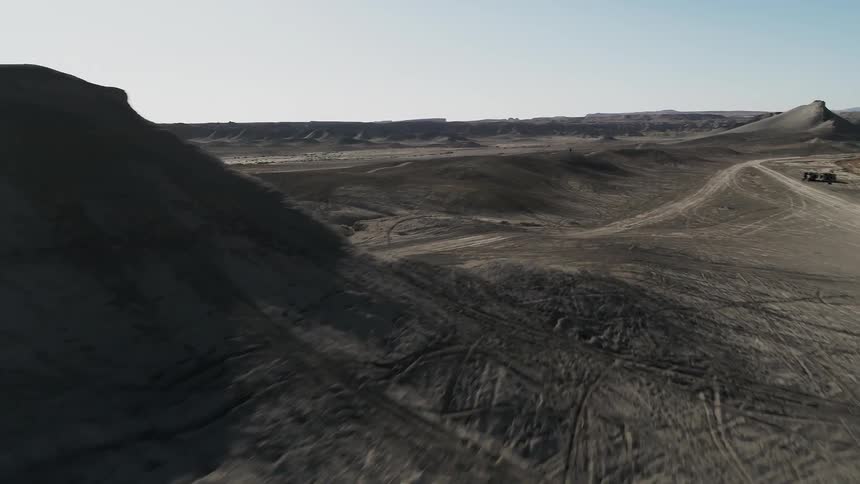 Dirt and hills cover a desert landscape