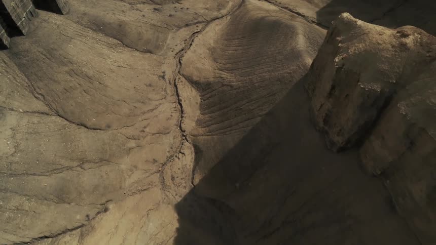 Sandy hilly desert with shadows overcasting