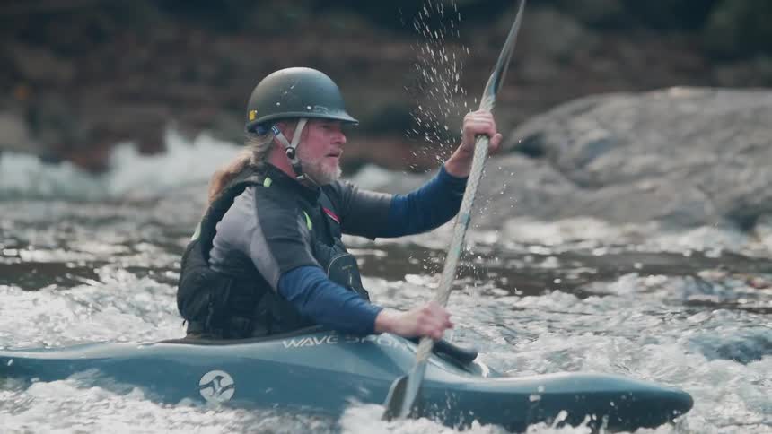 Man kayaks on a river