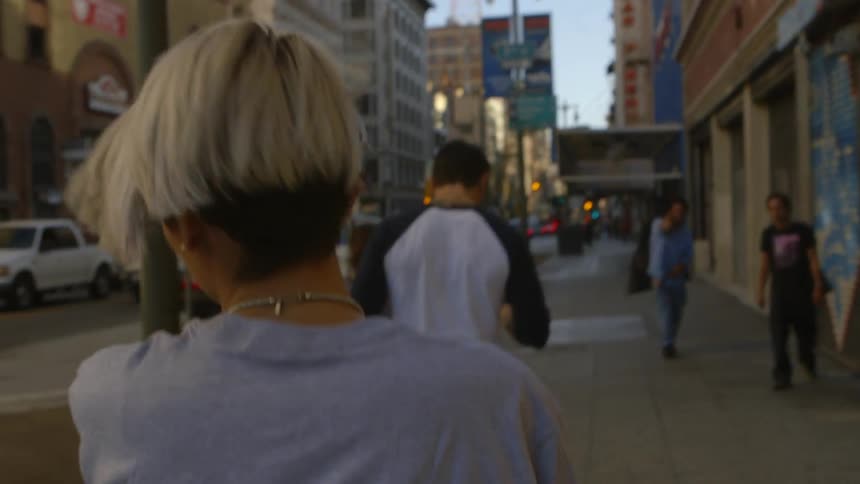 People are walking down a city street