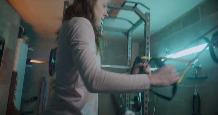 A woman exercises in a home gym