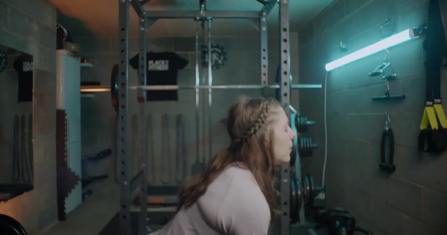 A woman works out by squatting and standing