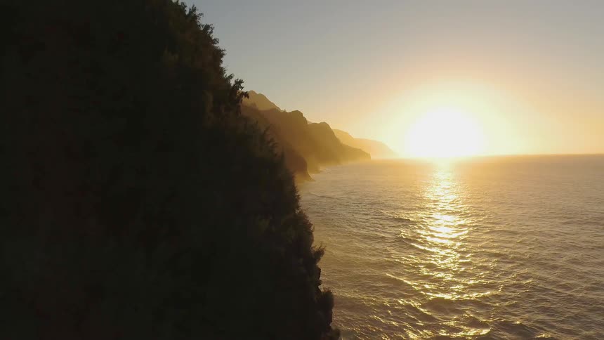 The sun is half set by the shore