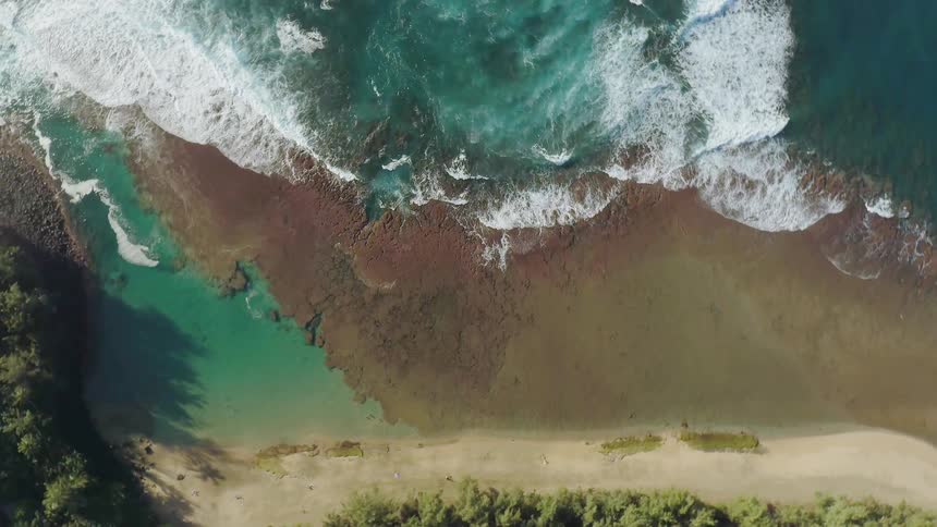 Water splashes to shore on a sandy beach
