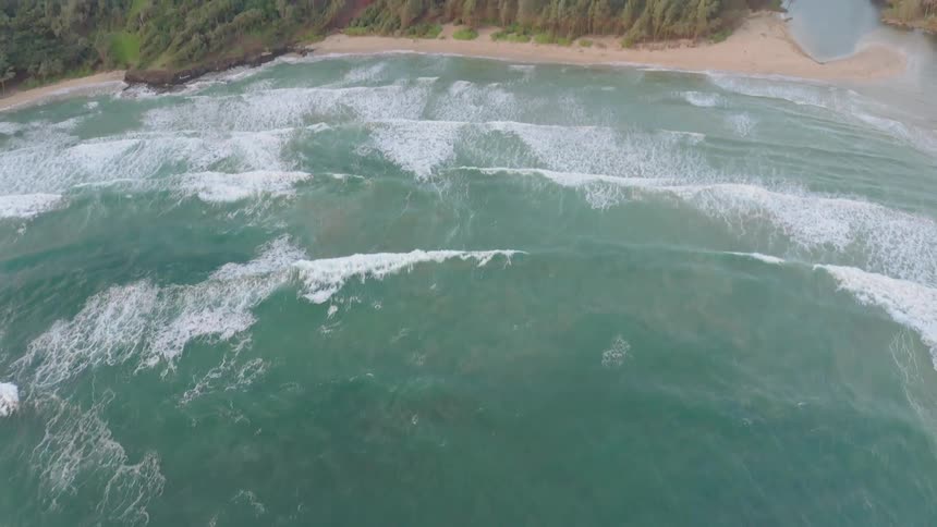 Ocean waves flow towards a beach