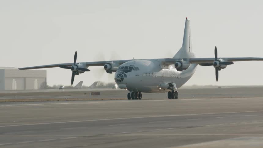 The large airplane is moving on the runway