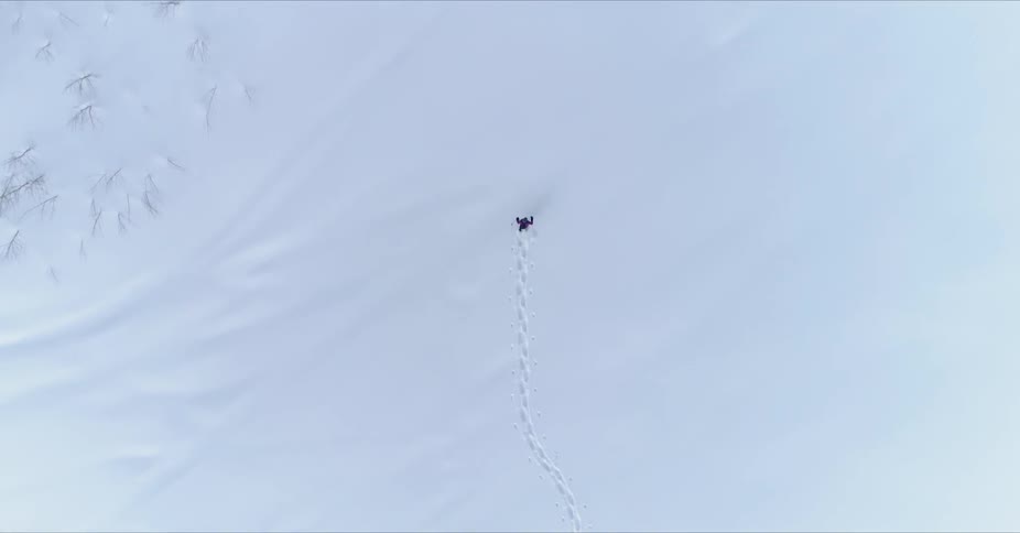 Person walking across a vast stretch of snowy land