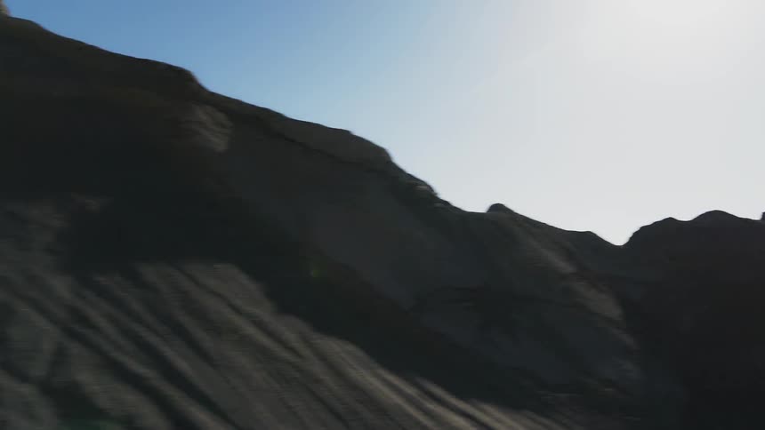 Large barren landscape with rocky hills all around