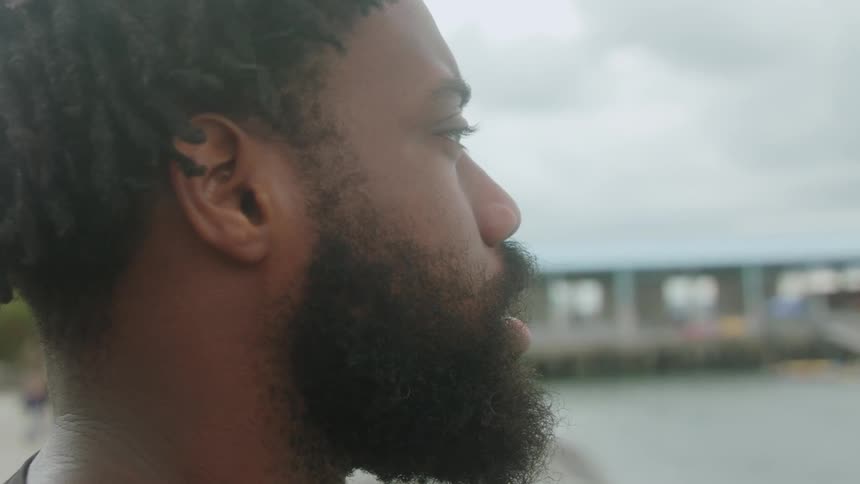 Man looks out across water