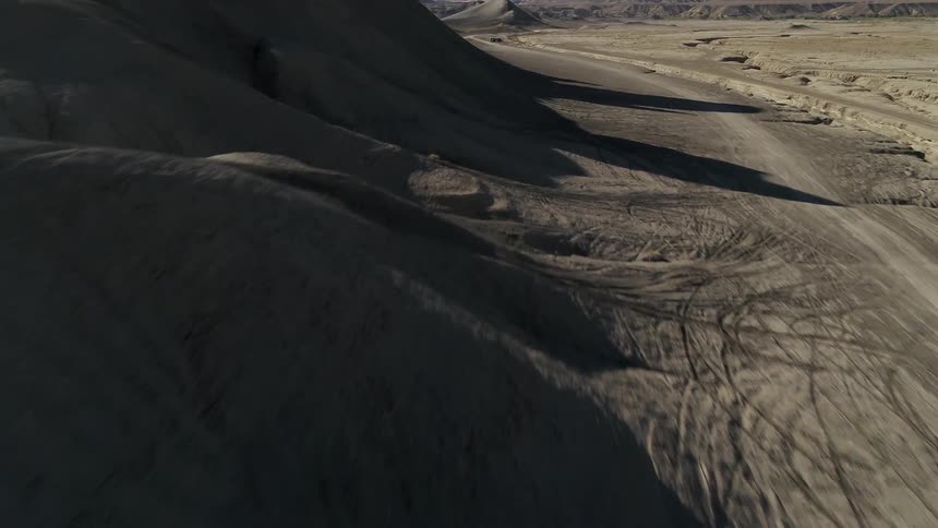 The hills cast shadows under the sun