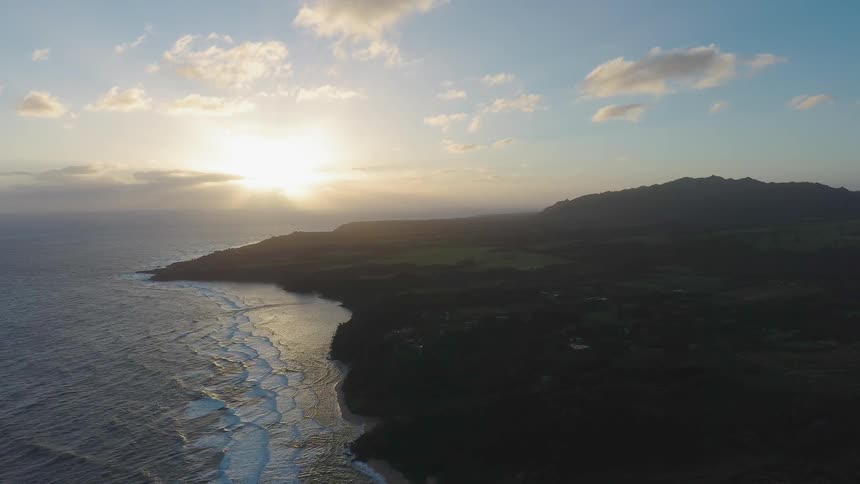 The sun is setting on the rough shores