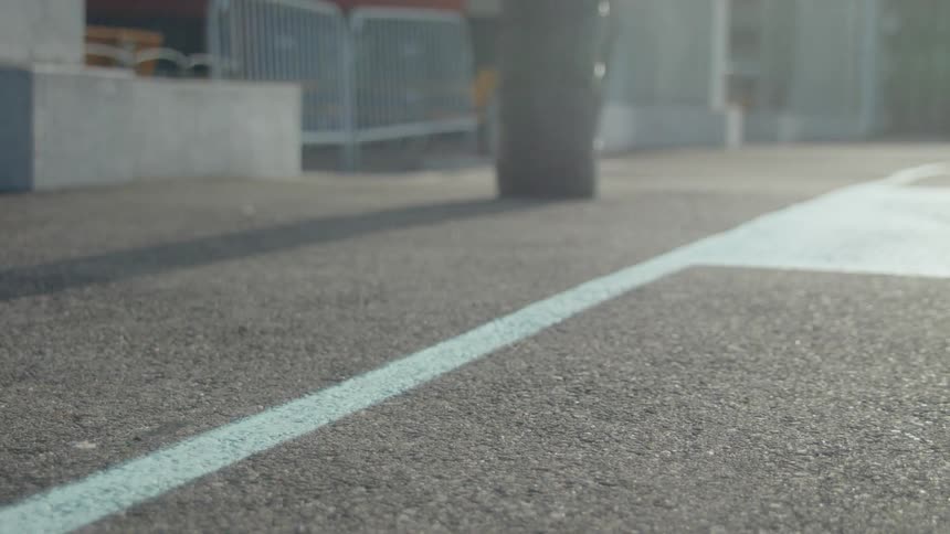 Person crouches near pavement and takes off running