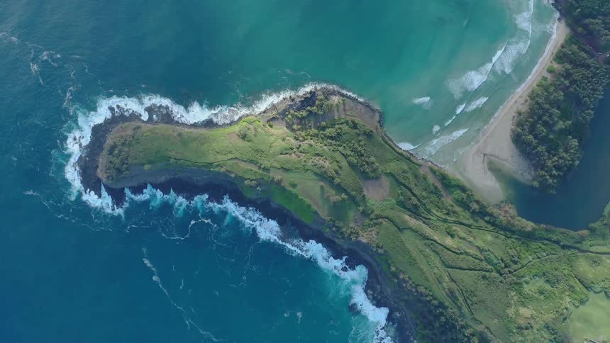 Ocean waves crashing against peninsula