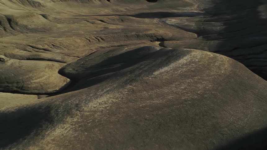 Sandy hilly desert with shadows overcasting