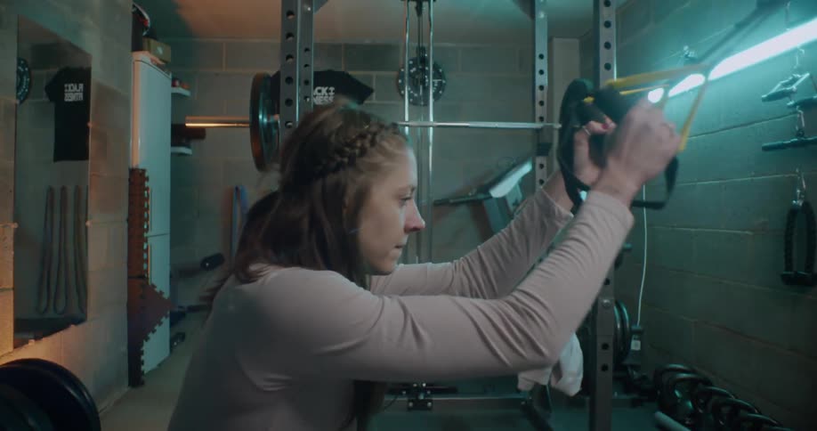 Woman does squats in a gym