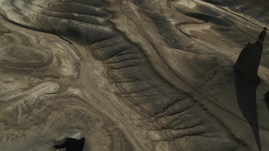 The rocky hills below are brown