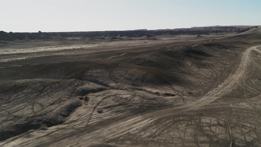 Dirt and hills cover a desert landscape