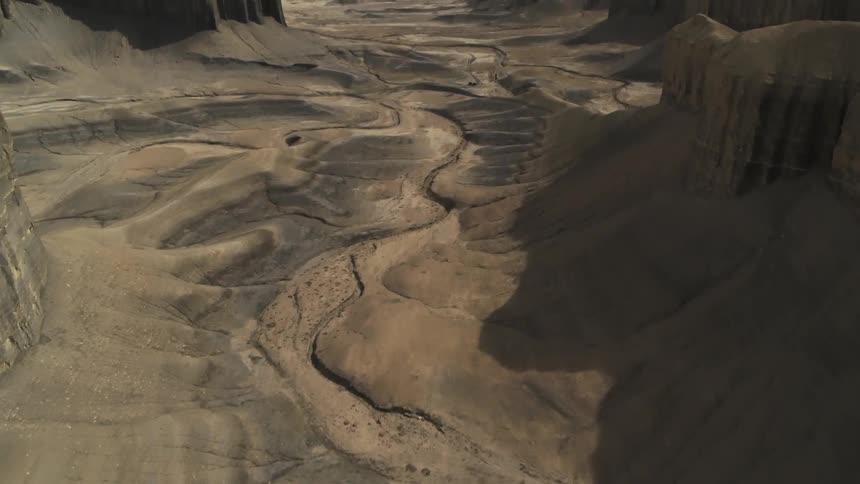 Dirt and cliffs cover a desert landscape