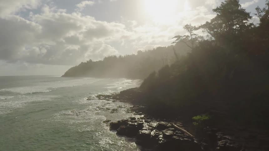 Sun shines over an island and flowing water