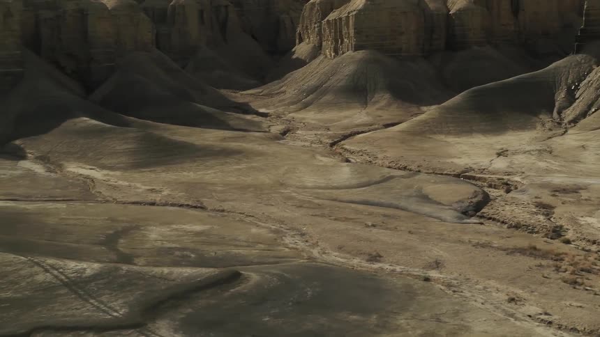 Cracks in the land sit at the base of the hills