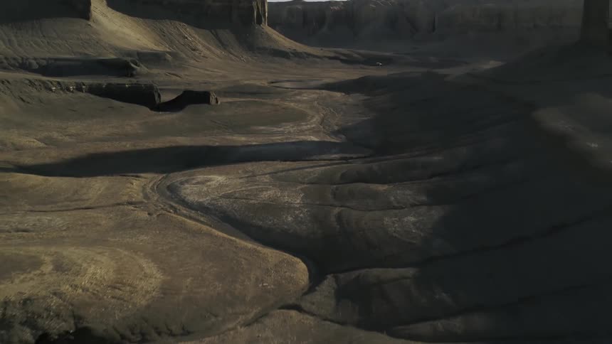 Dirt and hills cover a desert landscape