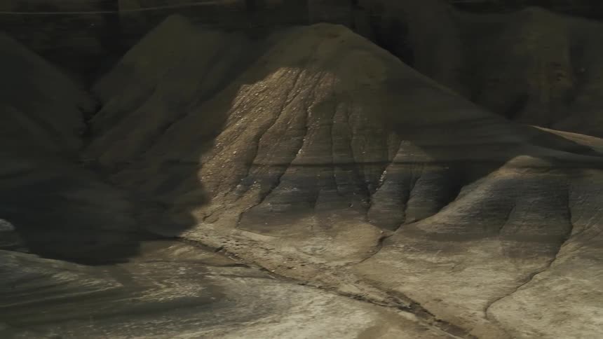 Shadows fall over a hilly desert