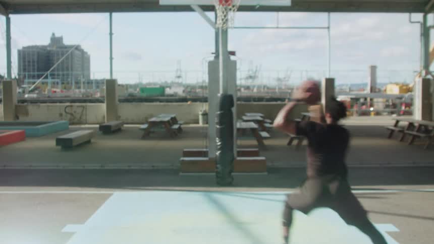 Man dribbles a basketball then takes a shot