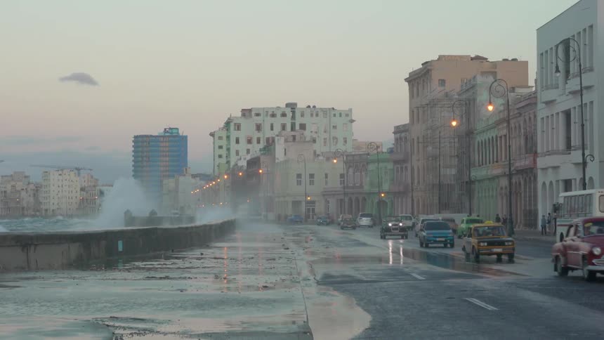 Water splashes up high on a water break in a city