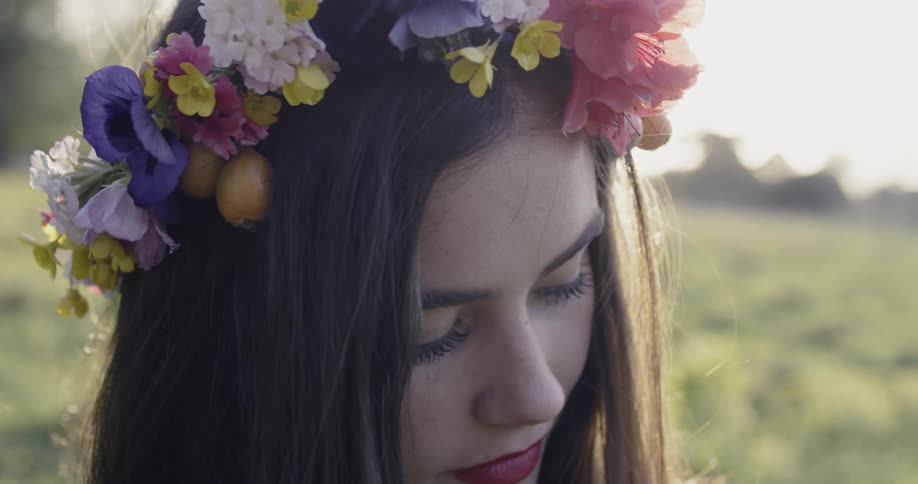Woman wears a flower wreath on her head on a sunny day