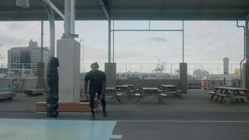 Man is sprinting outdoor on basketball court