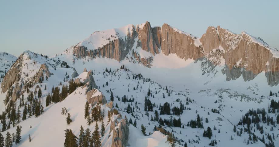 Snow covered mountains sit under a blue sky