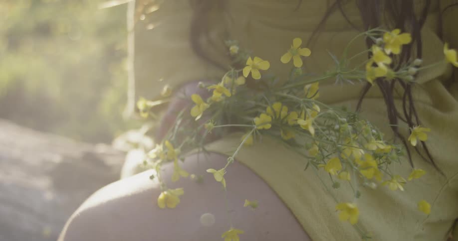 Someone is holding a bunch of tiny yellow flowers