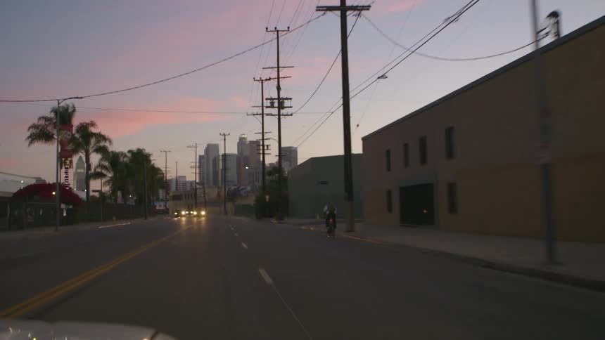 View from a car traveling down a tropical city street