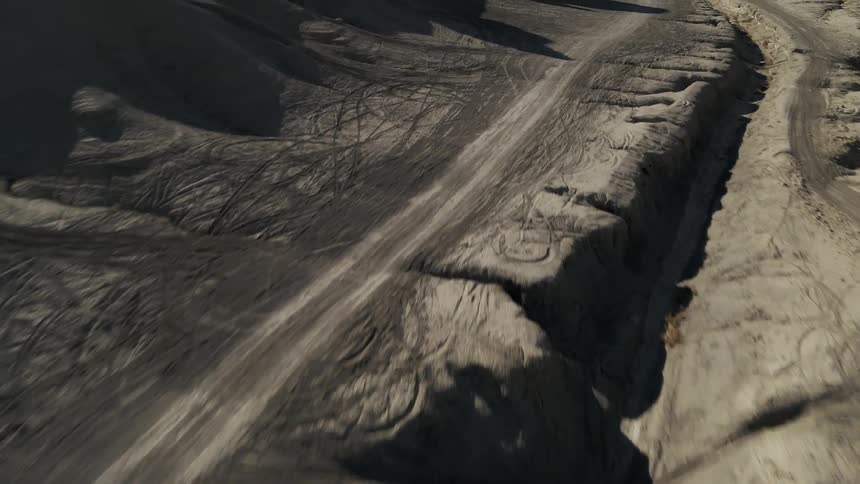 Tire trucks cover a desert landscape
