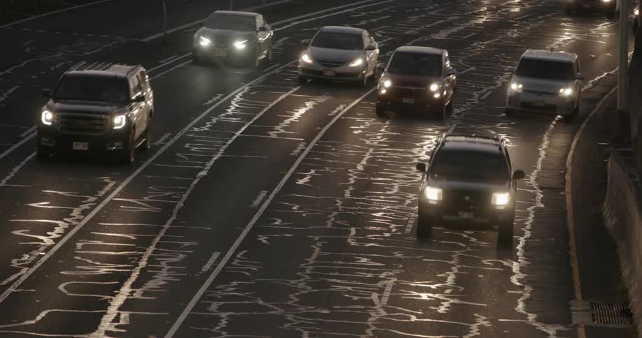 Cars drive on a street at night