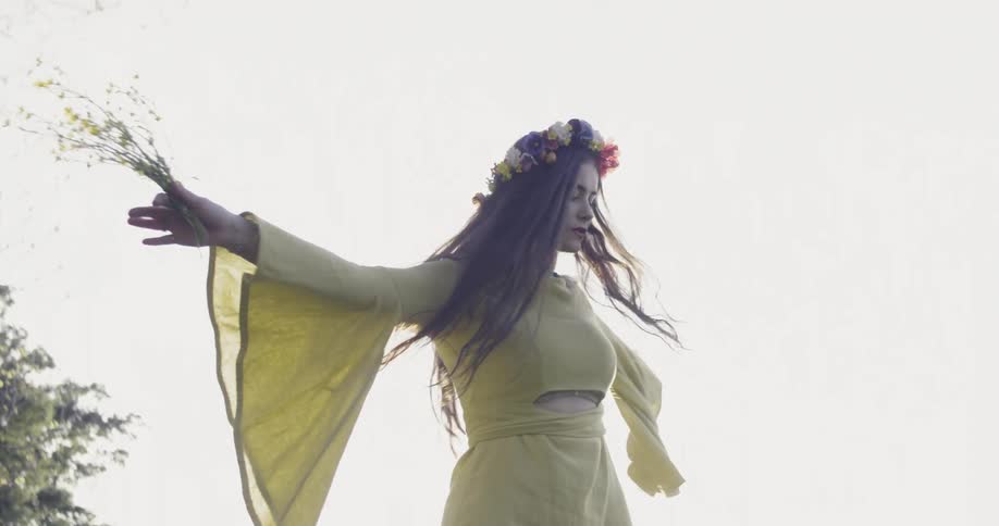 Woman with a flower garland in her hair spins around