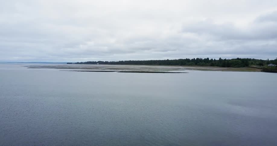 Clouds are hanging over a coastline during the day