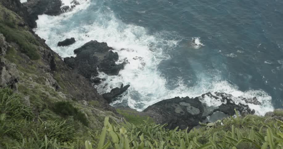 Ocean waves crash into a shore