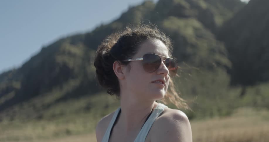 Woman wearing sunglasses looks over her shoulder