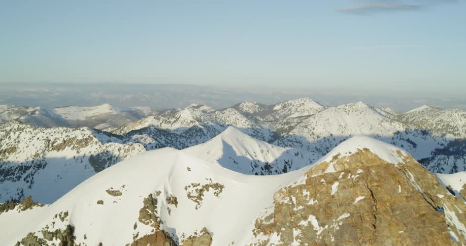 Snow covers rocky peaks on a sunny day