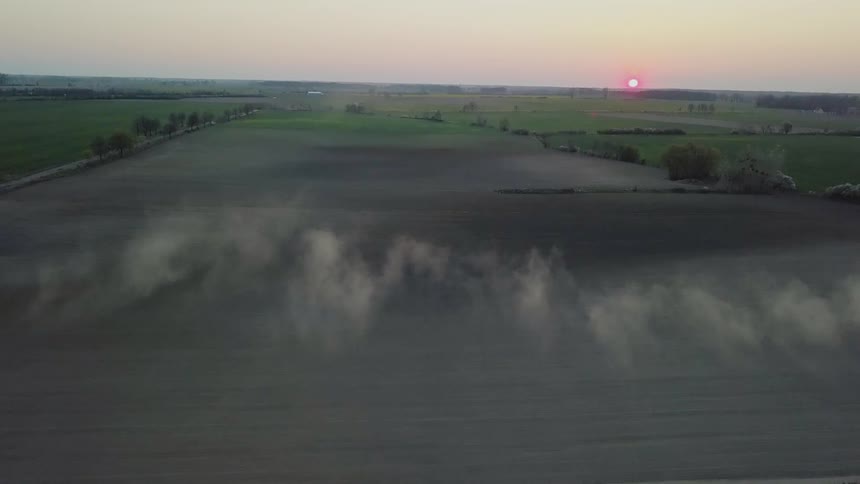 Mist floats over the land under a cloudy sky